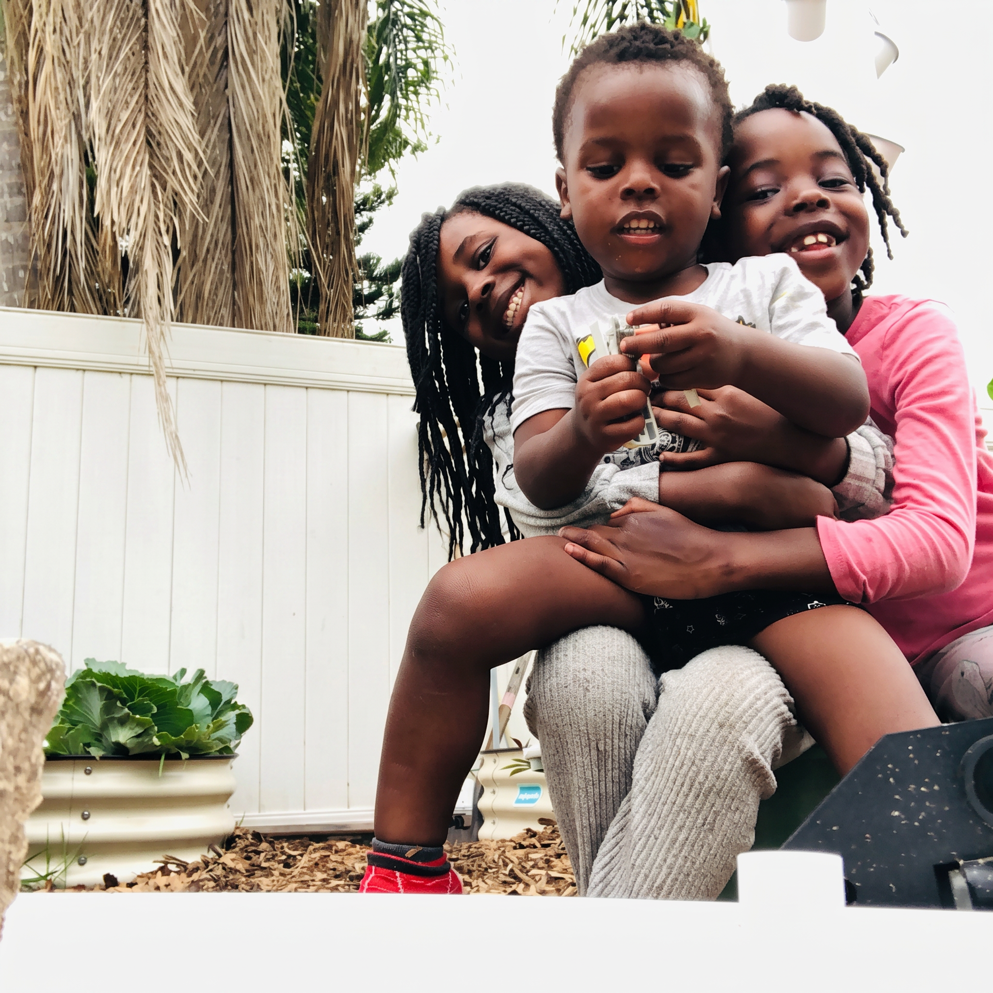 Three Saint Livingstone siblings together in the garden